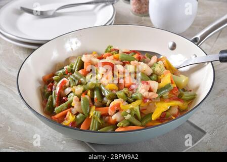 Gourmet Garnelen rühren braten mit grünen Bohnen und Paprika in einer Gusseisen Pfanne Stockfoto
