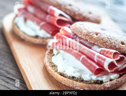 Scheiben von Jamon und Sandwich mit Frischkäse Stockfoto