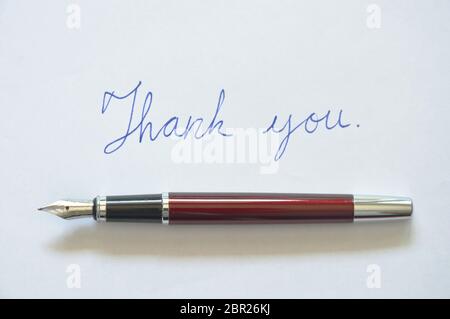 Füllfederhalter schreiben danke Wort auf weißem Hintergrund Stockfoto