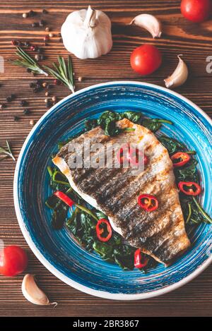 Gegrillte Dorade Fischfilet mit Spinat und Chili Stockfoto