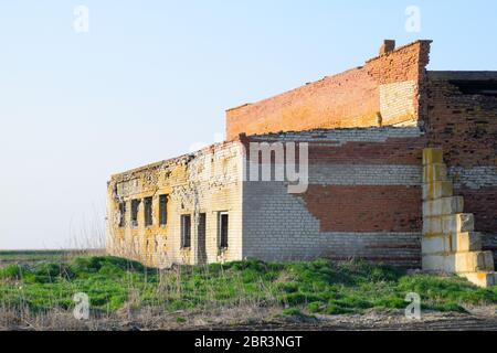 Alte sowjetische Brick verlassene Gebäude. Einstürzende gemauerte Konstruktion. weißen und roten Backstein Stockfoto