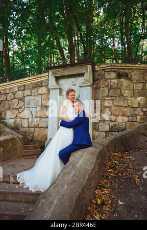 Frisch verheiratetes Paar im Park. Ich habe gerade geheiratet. Spazieren Sie im Park und umarmen Sie sich. Stockfoto