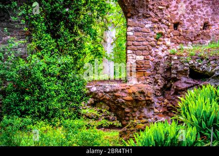 Fenster brick Ruinen Efeu pflanze Hintergrund im Giardino della Ninfa Gärten in Latina - Latium - Italien Stockfoto