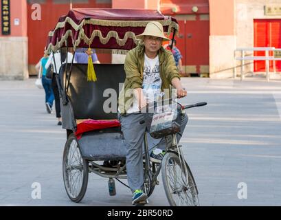 Peking / China - 21. Mai 2016: Fahrrad Rikscha Fahrer wartet auf Kunden in Peking, China Stockfoto
