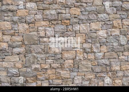 Dekorative und unregelmäßigen Steinmauer. Ideal für Texturen und Hintergründe. Stockfoto