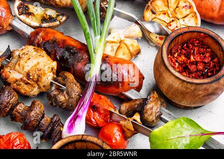 Zusammenstellung der Gerichte vom Grill, Kebabs, Würstchen und gegrilltem Gemüse Stockfoto