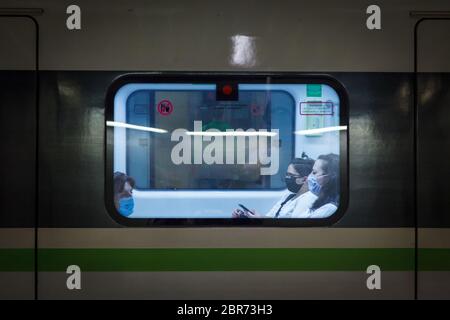 Passagiere in Athener Metro-Wagen tragen Schutzmasken, wie es die griechische Regierung aufgrund des Coronavirus-Ausbruchs angewiesen hat. Stockfoto