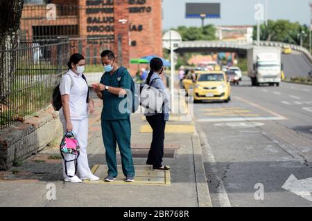 Menschen auf der Straße während des Coronavirus-Ausbruchs in Kolumbien Junge Frau mit Gesichtsmaske, die sich auf dem Autospiegel spiegelt, Kolumbien Stockfoto