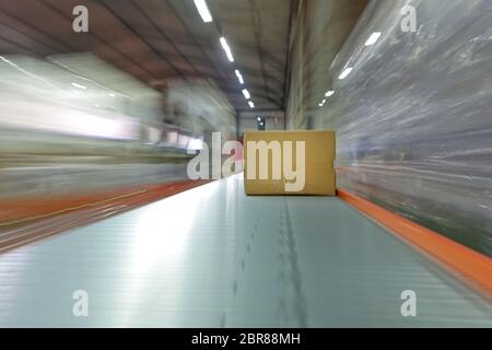 Versandkartons am Transportband im Versandlager Stockfoto