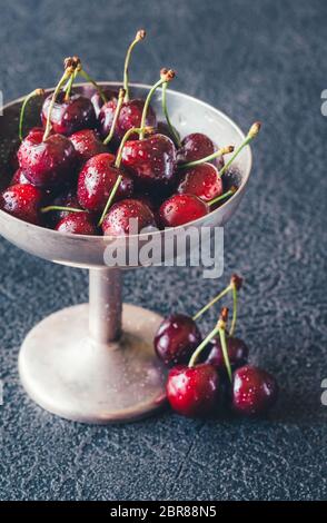 Frische Kirschen in Vintage silver Vase auf dem dunklen Hintergrund Stockfoto