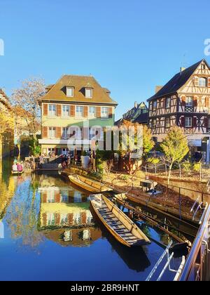 Farbenfrohe romantische Stadt Colmar, genannt Klein Venedig in Frankreich, im Elsass. Traditionelle Häuser am Ufer des Flusses und Boote schwimmend in der Nähe der Pier. Mittelalterliche Stockfoto