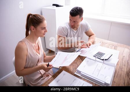 Junge Paare streiten über teure Rechnung zu Hause Stockfoto