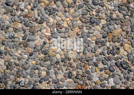 Hintergrund Textur der Pflaster Pellets. Kieselsteine in Beton. Stockfoto