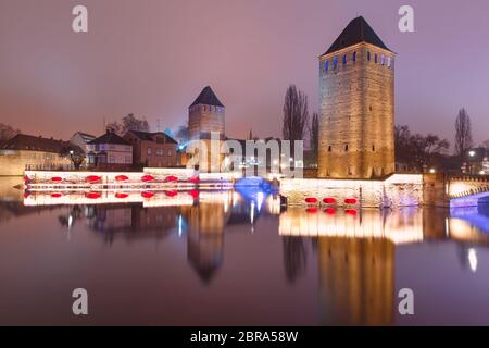 Die mittelalterlichen Türme und Brücken mit Spiegel Reflexionen in der Petite France, abends, Straßburg, Elsass, Frankreich Stockfoto