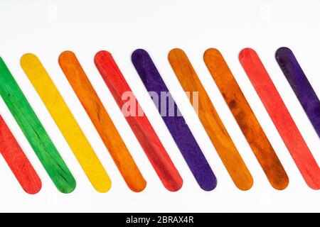 Reihe der farbigen Holzlatten auf eine weiße Fläche Stockfoto