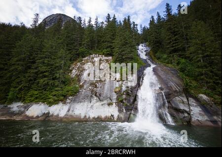 Hole in the Wall Waterfall, Tracy Arm, Südost-Alaska, USA, ist eine landschaftlich reizvolle Aussicht, die Touristen auf kleinen Schifffahrten und Bootstouren groß macht. Stockfoto