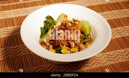 DAN DAN GLUTENFREIE NUDELN MIT MAIS, PAK CHOY, PILZE, CAPSICUM, ZWIEBELN, SPINAT Stockfoto