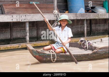 Lächelndes Mädchen auf einem Flussboot im schwimmenden Dorf Kompong Luong. Krakau, Kambodscha, Südostasien Stockfoto