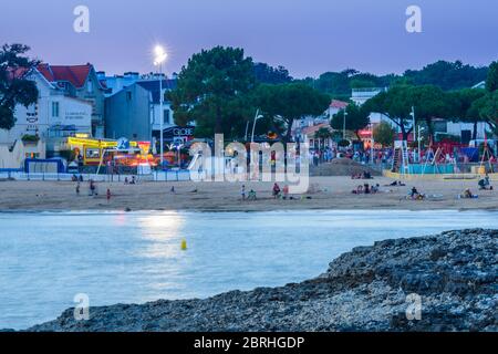 Saint-Palais-sur-Mer, Frankreich: Der Strand Plage du Bureau im Stadtzentrum mit Restaurants, Hotels und Geschäften im Hintergrund, bei Sonnenuntergang. Stockfoto