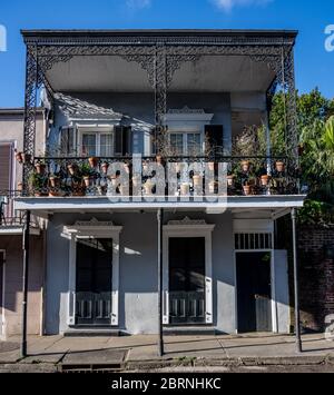 Blumentöpfe hängen vom Balkon mit schmiedeeisernen Details Stockfoto