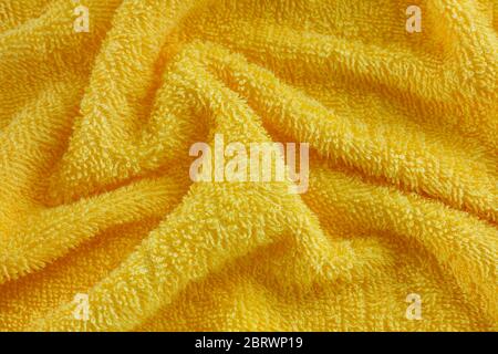 Wrinkled yellow towel texture background. Close up. Stockfoto