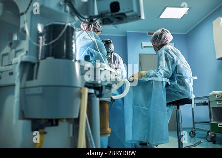 Krankenhaus, Operationssaal. Lebensrettend. Beatmung der Lunge mit Sauerstoff. Vor dem Hintergrund eines Teams von Chirurgen während der Stockfoto