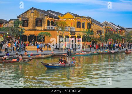 Hoi an, Vietnam - 9. Februar 2018 : selektiver Fokus auf Touristen sitzen auf einem kleinen Holzboot mit Vietnamesen rudern. Sehen Sie sich die antike Stadt an Stockfoto