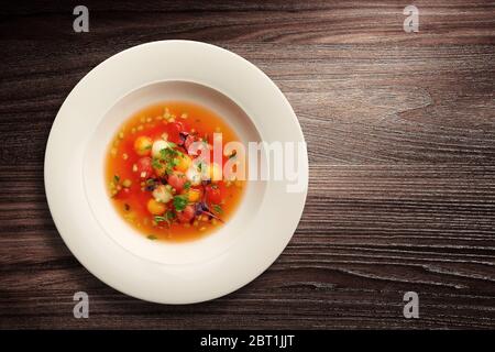 Direkt über Aufnahme einer stilvollen Schüssel Gemüsesuppe auf Holzhintergrund Stockfoto