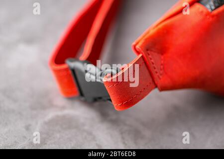 Rote Hüfttasche aus Leder, Banane auf grauem Hintergrund. Handgefertigt Stockfoto