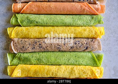 Pfannkuchen in verschiedenen Farben. Spinat, Rote Beete Pulver, Heidelbeere und Kurkuma Crepes. Stockfoto