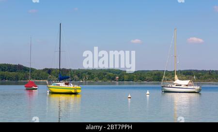 Idyillisches Panorama des Ammersee mit ankenden Segelbooten. Blauer, klarer Himmel. Der Ammersee ist ein beliebtes Ausflugsziel. Stockfoto