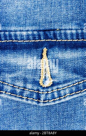 Bekleidung blau stonewashed verwaschene Jeans Baumwollstoff Textur mit Nieten, Schnallen, Knöpfe und Nieten, Makro, Nahaufnahme Stockfoto