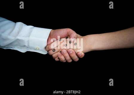 Nahaufnahme eines Mannes, der die Hand einer Frau mit Coronavirus COVID-19 schüttelt Stockfoto