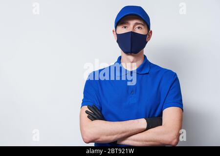 Courier trägt gelbes T-Shirt und Mütze. Konzept der Lieferung, Online-Shopping, kontaktlose Zahlung. Stockfoto