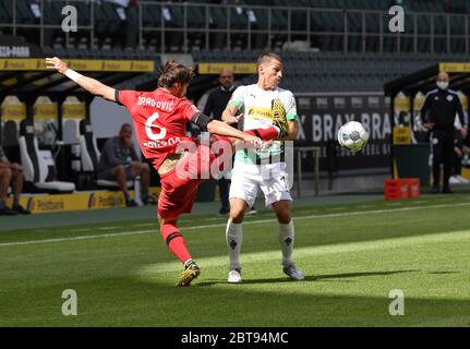 Borussia Park Mönchengladbach Deutschland, Fußball: Bundesliga-Spieltag 27, Borussia Mönchengladbach (BMG, weiß) gegen Bayer 04 Leverkusen (B04, rot) 1:3 – Aleksandar Dragovic (Bayer 04 Leverkusen), Stefan Lainer (Borussia Mönchengladbach). Aufgrund der Corona-Virus-Pandemie werden alle deutschen Ligaspiele in leeren Stadien ohne Zuschauer gespielt. Foto: Maik Hölter/team2sportphoto/Pool/via Kolvenbach nur für redaktionelle Verwendung! Die DFL-Bestimmungen verbieten die Verwendung von Fotos als Bildsequenzen und/oder quasi-Video. Stockfoto