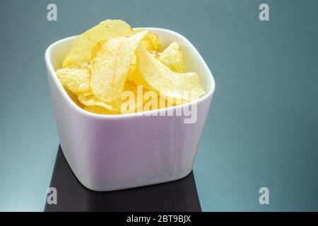 Kartoffelchips oder Chips auf schwarzem Spiegelhintergrund Stockfoto