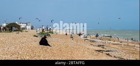 Worthing UK 24. Mai 2020 - Besucher und Kitesurfer genießen das windige, aber sonnige Wetter in Goring by Sea bei Worthing in West Sussex an diesem Feiertagswochenende während der COVID-19 Pandemie. : Credit Simon Dack / Alamy Live News Stockfoto