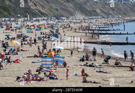 Die Menschen genießen das heiße Wetter am Strand von Boscombe in Dorset, nachdem Maßnahmen eingeführt wurden, um das Land aus der Blockierung zu bringen. Stockfoto