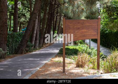 Große leere Holzplakate auf grünem Hintergrund Stockfoto