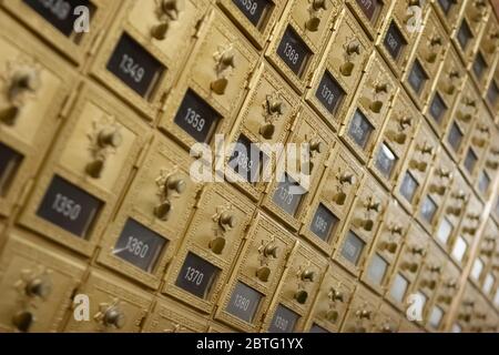 Reihe von Vintage Messing Einsteckfächer mit Türen und Kombination Schlösser in einem Postraum. Stockfoto