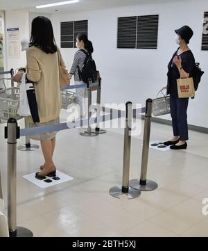 Die Käufer halten eine soziale Distanz zwischen einander, während sie am 25. Mai 2020 im Matsuya Ginza Kaufhaus in Tokio, Japan, Schlange stehen, um zu bezahlen. Quelle: AFLO/Alamy Live News Stockfoto