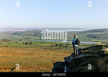 Walker Genießen Sie den Blick über den Blackton Reservoir von Goldsborough Crag auf der Bowes Loop des Pennine Way, Baldersdale, Teesdale, County Durham, Großbritannien Stockfoto