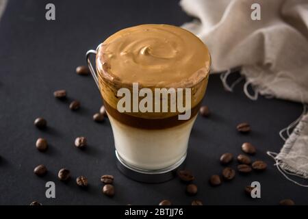 Cremiger eisiger Dalgona Kaffee auf schwarzem Hintergrund Stockfoto