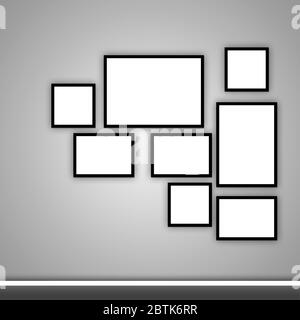 Leere Fotorahmen in verschiedenen Größen an einer grauen Wand. Wandgestaltung mit Bilderrahmen. Stockfoto