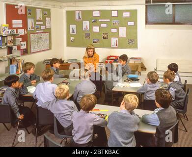 Lehrerin, die in der Klasse liest, Surrey, England, Großbritannien Stockfoto