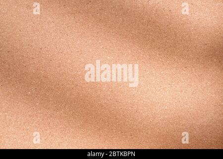 Beigefarbene Korkoberfläche mit Schatten aus nächster Nähe. Makrotextur und Hintergrund Stockfoto