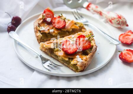 Scheiben Erdbeer und Rhabarber Pie auf weißem Teller. Draufsicht. Hausgemachte Bäckerei. Stockfoto