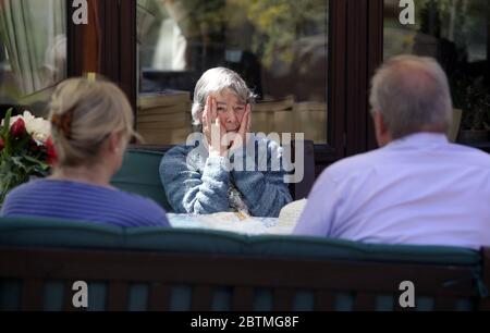 Margaret Yeoman, 90, sieht ihren Sohn John Yeoman, 62, und seine Frau Denise Yeoman, 63, zum ersten Mal seit acht Wochen, als sie sie im Pflegeheims Eothen Homes in Whitley Bay, Tyneside, ihrem ersten persönlichen Kontakt seit Beginn der Lockdown, besuchen. Stockfoto