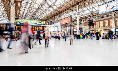 Victoria Station, London, Großbritannien. Lange Belichtung Zusammenfassung der Reisenden und Pendler auf dem Gang eines der größten Bahnhöfe der Stadt. Stockfoto