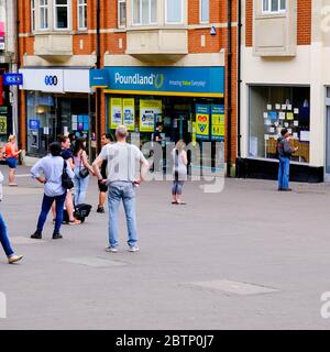 Eine Reihe von Menschen Queuing außerhalb Poundland Discount Store in South london während der Coronavirus Pandemie Stockfoto